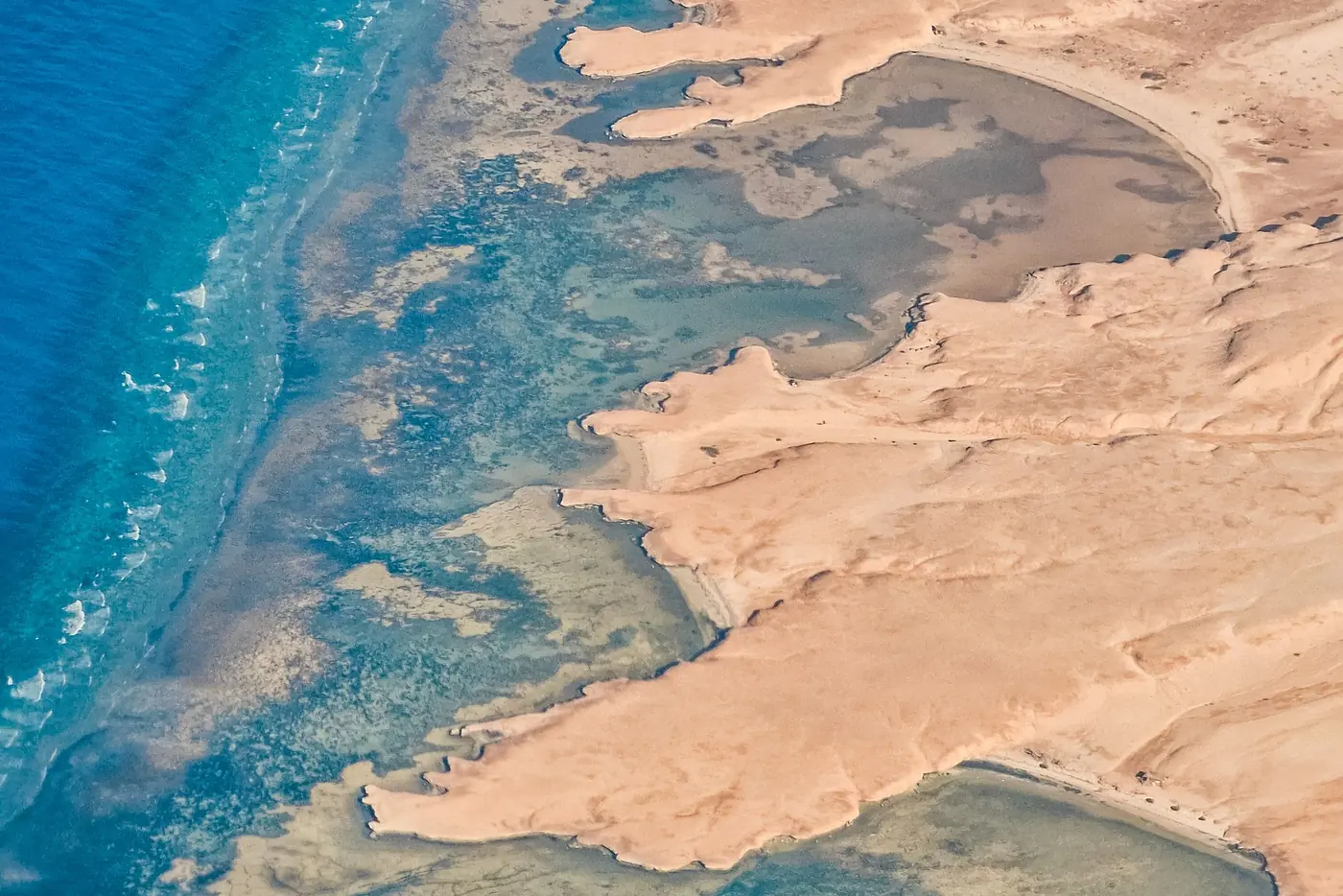 The Red Sea coast of Egypt from above, with turquoise reef water meeting the desert shore