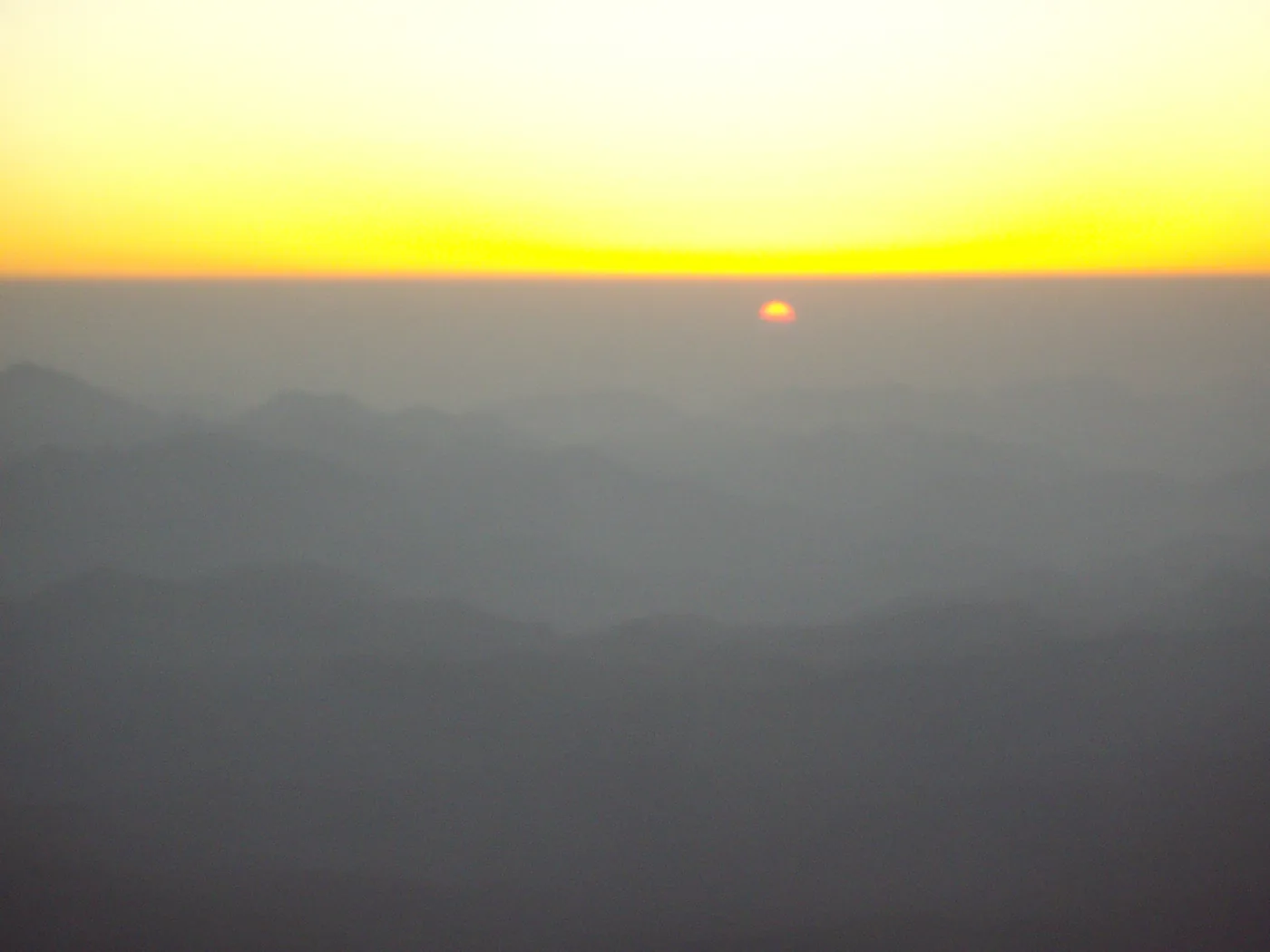 Sunrise over the ridges of the Sinai mountains seen from the summit of Mount Sinai